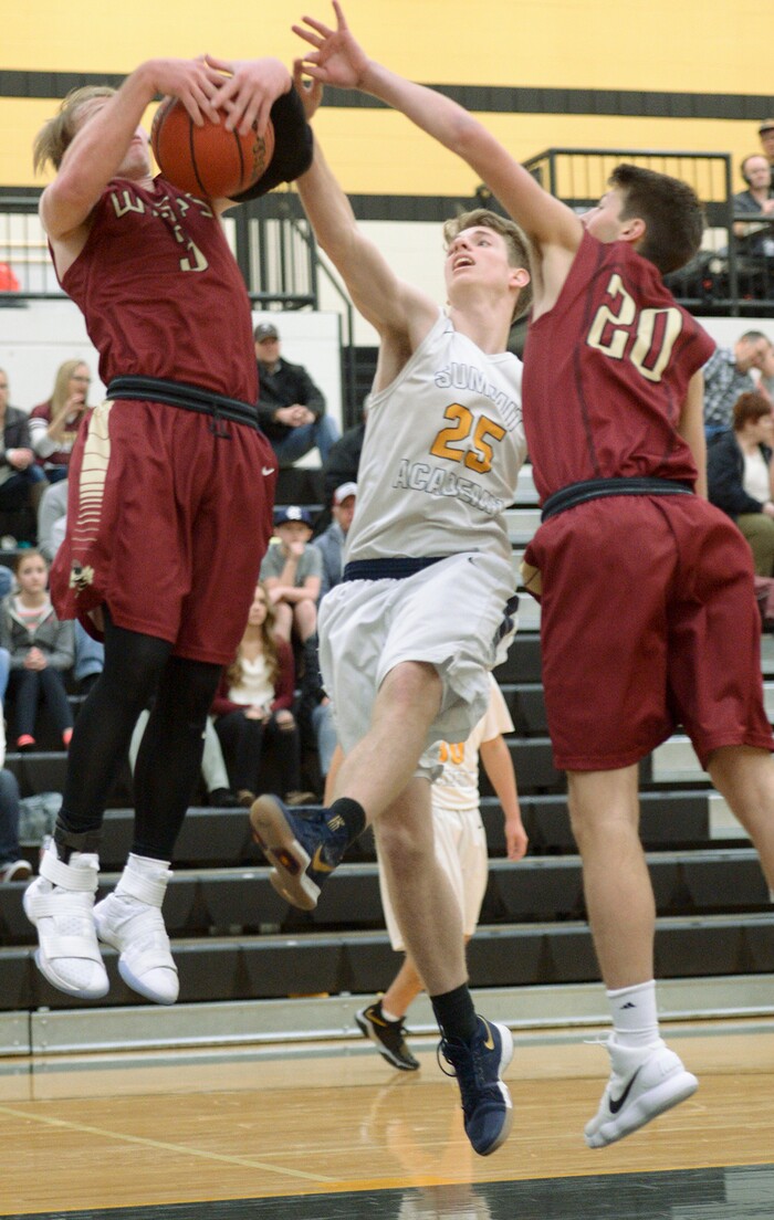 (Leah Hogsten  |  The Salt Lake Tribune) Juab's Alex White pulls down the rebound over Summit's Gerritt Vader Linden.  Juab High School boys' basketball team defeated Summit Academy 61-58 during their 3A State tournament game in Heber  Saturday, Feb. 16, 2018.