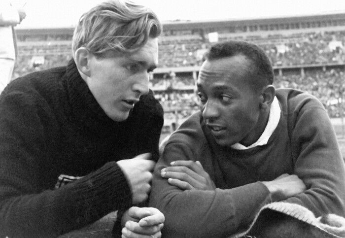 (courtesy photo) American Olympian Jesse Owens (right) talks to German competitor Luz Long during a down moment in the 1936 Olympic Games in Berlin. Owens' triumph, winning four gold medals, was one of the events captured in filmmaker Leni Riefenstahl's controversial 1938 documentary "Olympia."