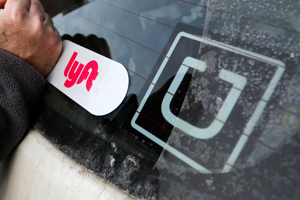 (Gene J. Puskar | AP photo)

In this Jan. 31, 2018, photo, a Lyft logo is installed on a Lyft driver's car next to an Uber sticker in Pittsburgh.