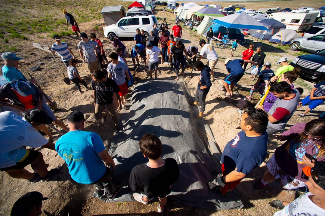 (Trent Nelson | The Salt Lake Tribune)  Descendants of the Hawaiians who settled the desert town of Iosepa attend a Memorial Day gathering, Saturday May 26, 2018. A pig is put into a BBQ.