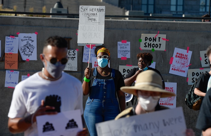 (Francisco Kjolseth  |  The Salt Lake Tribune) Protesters gather at the Utah Capitol to rally against police brutality on Friday, June 26, 2020. Protesters had taped signs to the facade outside the Capitol but removed them before leaving.