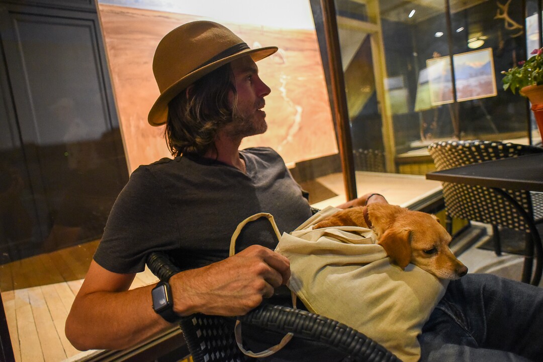 (Francisco Kjolseth  |  The Salt Lake Tribune)  George Waldren of Scottsdale, Arizona and his dog Lulu enjoy the scene along Main Street in Helper, Utah as people explore art galleries and studios during Helper First Fridays on Friday, Aug. 2, 2019. Entering its second year of existence on the first Friday of each month, the gallery stroll draws young and old with live music, entertainment, outdoor activities and a chance to engage with numerous artists who have made the small Utah town home.