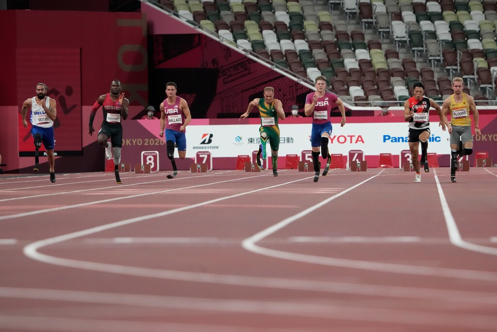 (Eugene Hoshiko | AP) United States' Hunter Woodhall, third from right, competes during the men's 100m T64 heats in the 2020 Paralympics at the National Stadium in Tokyo, Sunday, Aug. 29, 2021.