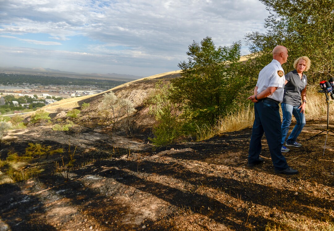 Leah Hogsten  |  The Salt Lake Tribune  l-r Salt Lake City Mayor Jackie Biskupski and Salt Lake City Fire Chief Karl Lieb hold a press conference in the burned area near Salt Lake City’s Ensign Peak. Five people were injured and one home was damaged by a fast-moving grass fire on Columbus Court, Tuesday, July 24, 2018. Forty homes were evacuated as flames spread through about 100 acres. Between 50 and 60 firefighters responded to the fire.