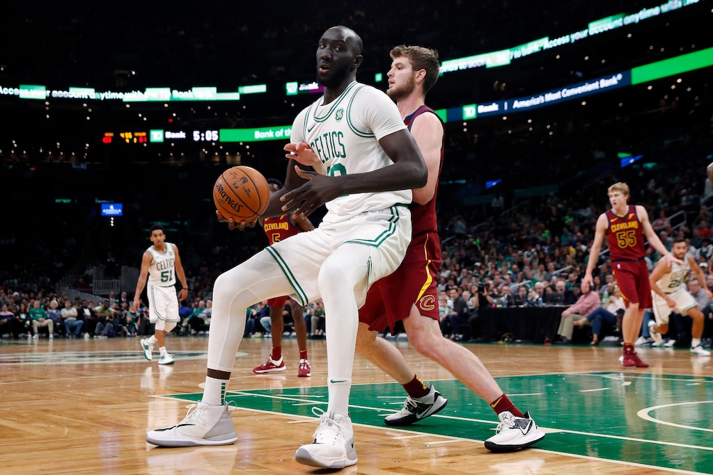 FILE - In this Oct. 13, 2019, file photo, Boston Celtics' Tacko Fall, left, looks to move against Cleveland Cavaliers' Dean Wade during the second half of an NBA preseason basketball game in Boston. Tacko Fall _ a two-way signee for the Celtics, at 7-foot-5 unquestionably the biggest man and most probably the biggest name in the G League to open this season _ might be the next in a rapidly growing line of G League success stories. The two-way contract has been a valuable tool for NBA clubs and players. (AP Photo/Michael Dwyer, File)