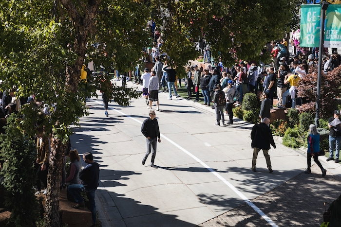 (Clark Clifford  |  Special to The Salt Lake Tribune) A man walks alone as a building crowd fills Olympic Plaza for Kanye West's Sunday Service at The Gateway in Salt Lake City on Saturday, Oct. 5, 2019.
