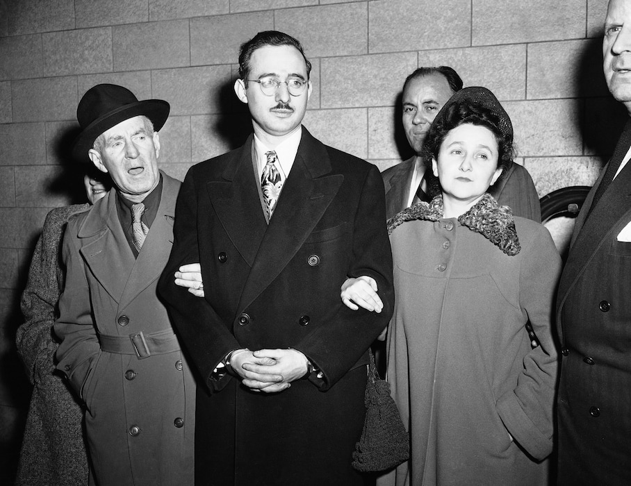 FILE - In this March 8, 1951 file photo from left, Harry McCabe, Deputy U.S. Marshall; Julius Rosenberg and wife, Eithel Rosenberg and Anthony H. Pavone, Deputy U.S. Marshall in New York. Julius Rosenberg, 33-year old electrical engineer from New York City and his wife were on trial on charges of conspiracy to commit espionage during World War II, involving U.S. atomic secrets. The sons of convicted spy Ethel Rosenberg are asking President Barack Obama to exonerate their mother. Michael and Robert Meeropol were presenting a letter at the White House on Thursday, citing unsealed court records they say cast doubt on their mother’s guilt. (AP Photo)