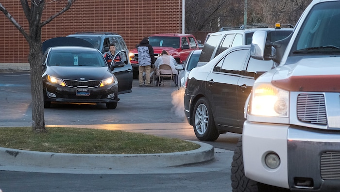 (Leah Hogsten | The Salt Lake Tribune) Volunteers hand out food from the Utah Food Bank to needy families, Dec. 23, 2020. One year ago, the Food Band was serving 75 families, but now they serve 325 families, said manager Kenneth Greenland. Cars begin lining up at 1pm for the 4:30pm start.
