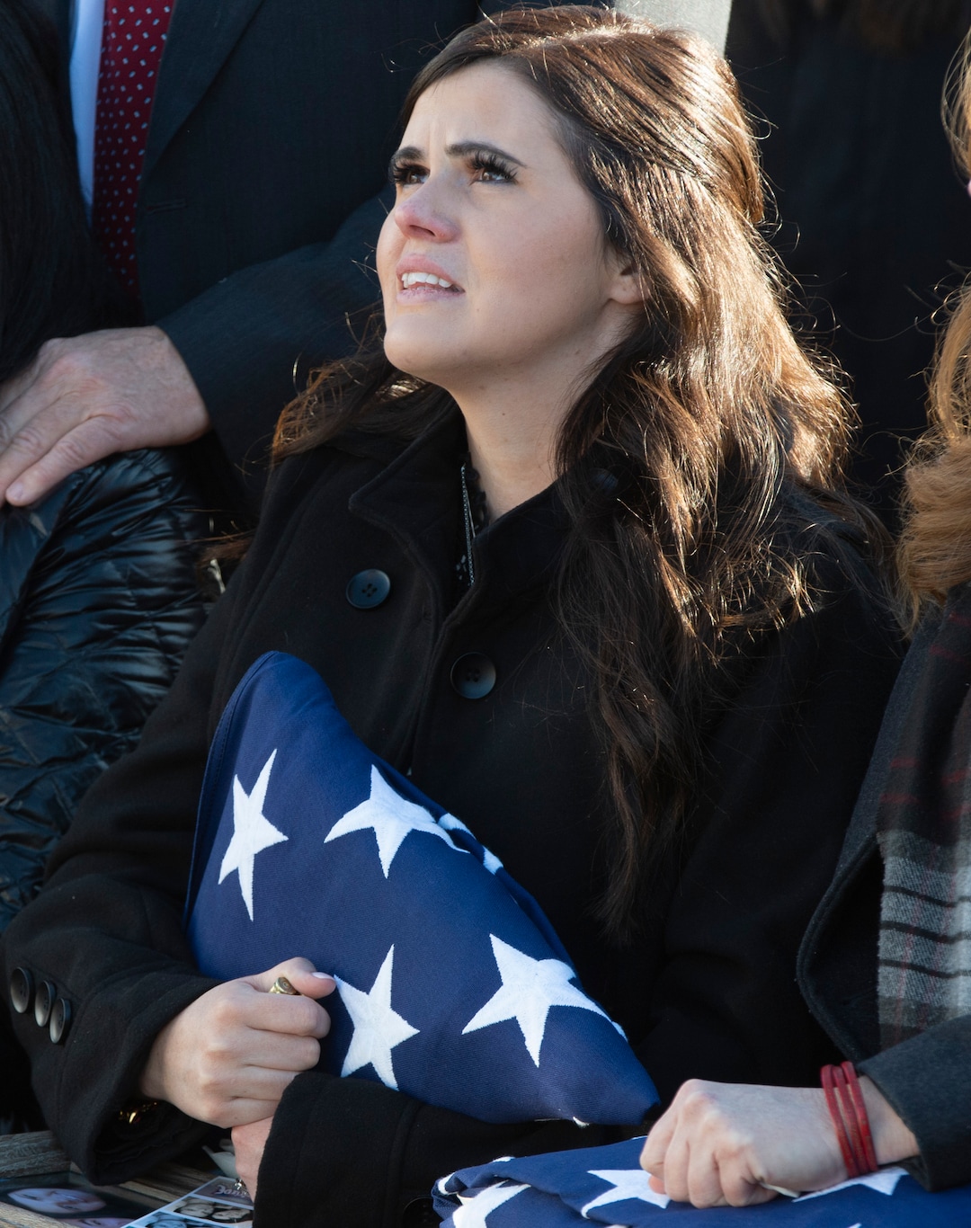 (Rick Egan  |  The Salt Lake Tribune)   McKenzie Fuchigami, holds the flag from her husbands casket  during the military fly-over, in the Brigham City Cemetery, during the the graveside service for her husband Kirk T. Fuchigami Jr. who was killed in Afghanistan.  Monday, Dec. 9, 2019.