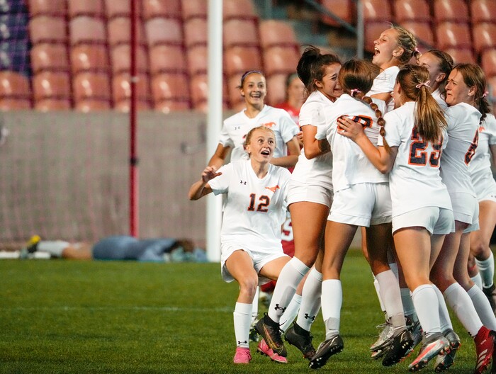 (Leah Hogsten | The Salt Lake Tribune) Mountain Crest  celebrates the win with teammate Summer Sofonia (13) after Crimson Cliffs' goalie Ellie Nielsen, left, could not stop Sofonia's free kick during the 4A State Soccer Championship game between Mountain Crest High School and Crimson Cliffs High School, Oct. 22, 2021 at Rio Tinto Stadium. Mountain Crest defeated Crimson Cliffs 1-0 in double overtime.