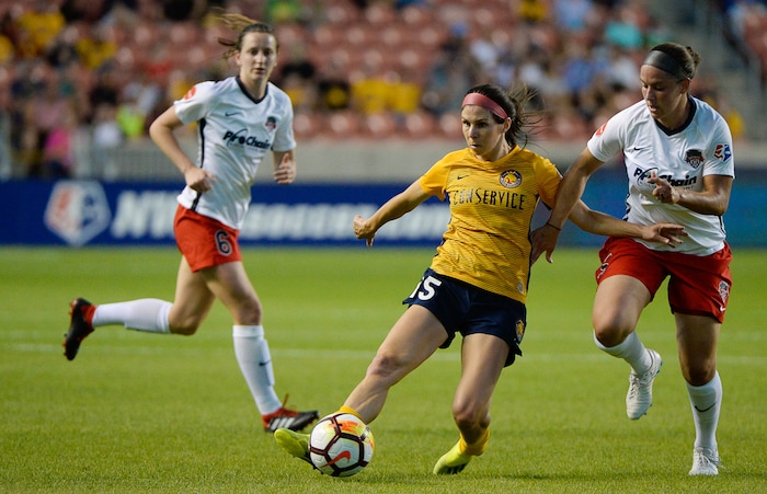 (Francisco Kjolseth  |  The Salt Lake Tribune)  Utah Royals FC hosts Washington Spirit, NWSL soccer at Rio Tinto Stadium in Sandy, Wed. Aug. 8, 2018. Utah Royals FC midfielder Erika Tymrak (15) tries to get past Spirit defenders in the first half of the game. 