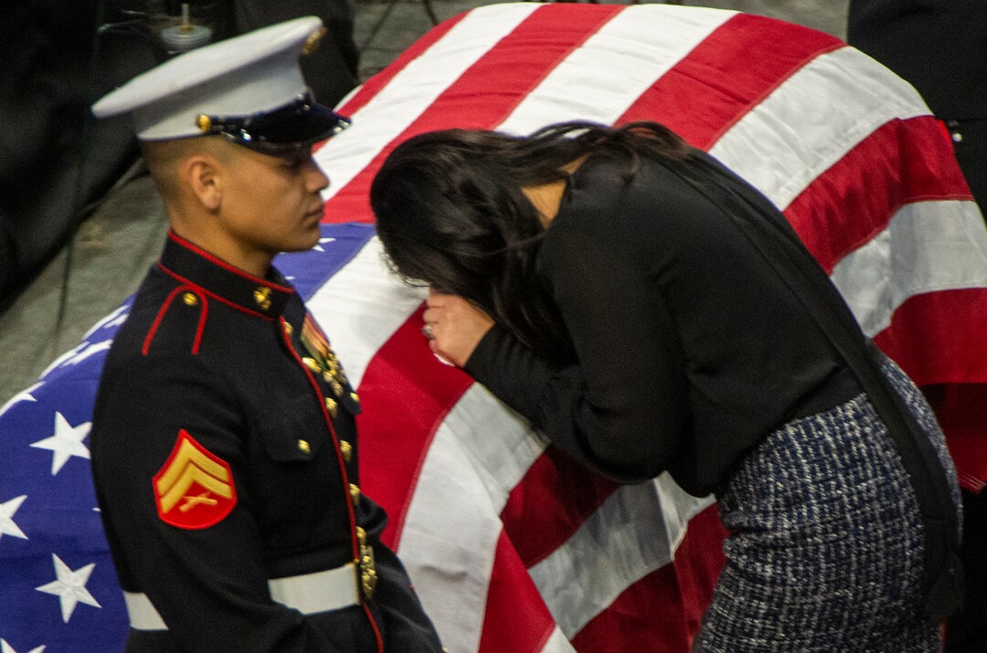 (Rick Egan  |  The Salt Lake Tribune)     Elizabeth Romrell spends a moment  by the casket of her husband, South Salt Lake police officer, David Romrell, before his funeral at the Maverik Center, in West Valley City, Wednesday, Dec. 5, 2018.