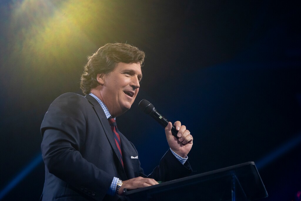 (Rebecca Noble | The New York Times) Tucker Carlson speaks during a Turning Point USA event in Phoenix, Dec. 18, 2023. A federal judge on Nov. 27, 2024 tossed out a defamation lawsuit against Fox News brought by a man who claimed that the networkÕs former star host, Tucker Carlson, had falsely accused him of being a government provocateur who instigated the violence at the Capitol on Jan. 6, 2021.