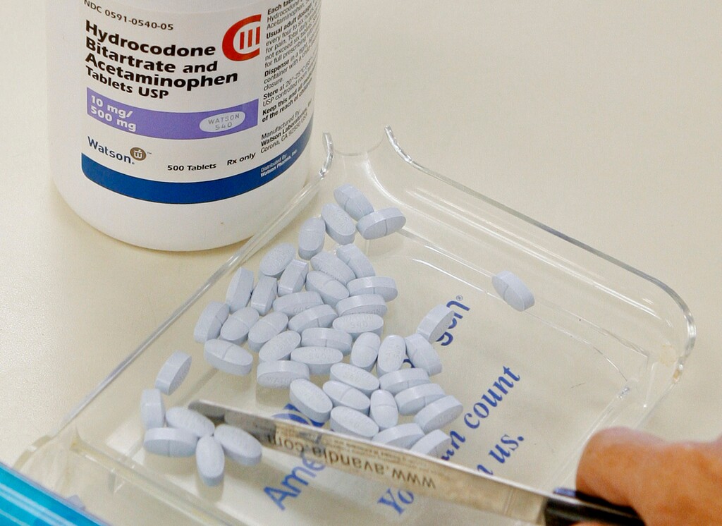 (AP file photo) A pharmacy technician in Oklahoma with hydrocodone and acetaminophen tablets, also known as Vicodin. The U.S. Department of Agriculture has announced a series of community meetings to discuss opioid addition in rural areas, including an April 11 event at the Utah Capitol. Anne Hazlett, assistant secretary for rural development at USDA, said the meetings are part of a new push by the agency to address the deadly crisis, which, Hazlett said, “has hit rural America particularly hard.”