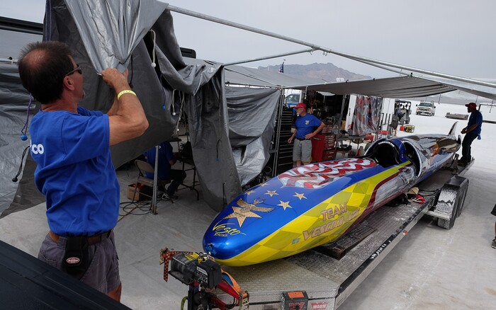 (Francisco Kjolseth  |  The Salt Lake Tribune)  Crew of the Vesco Turbinator from Rockville, Utah, cover the car following a run during Speed Week at the Bonneville Salt Flats outside Wendover on Monday, Aug. 14, 2017. The Turbinator is the fastest wheel driven vehicle with an international speed record of 458 miles per hour. 