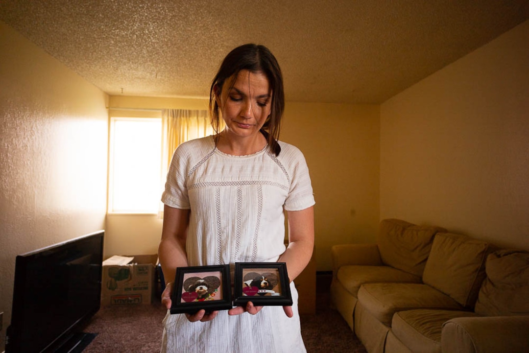 (Trent Nelson  |  The Salt Lake Tribune)  Michelle Densley gets emotional showing photos of two dogs she had to give up when her living conditions changed, at her apartment in Salt Lake County on Monday April 8, 2019.
