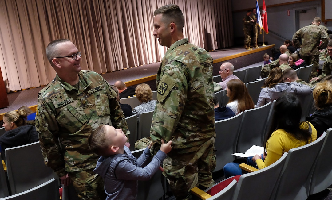 (Francisco Kjolseth  |  The Salt Lake Tribune) Chaplain Maj. Gene Whitmore, left, speaks with Lt. Taylor Blauer of Murray and his son Barrett, 5, prior to departure ceremonies for members of the 141st Military Intelligence Battalion at the Utah National Guard headquarters in Draper on Monday, March 19, 2018. 