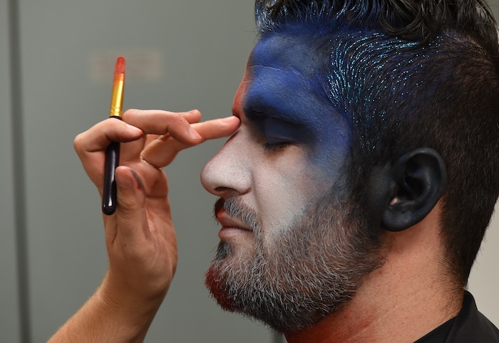 (Francisco Kjolseth | The Salt Lake Tribune) Makeup artist Kristen Packard works her magic on Brad Klekas of South Jordan, a BYU and Utah fan alike as he's willing to show his mutual admiration of both teams by stepping into the Tribune studio to get both colors in anticipation of the upcoming match up between the two rival teams on Saturday.
