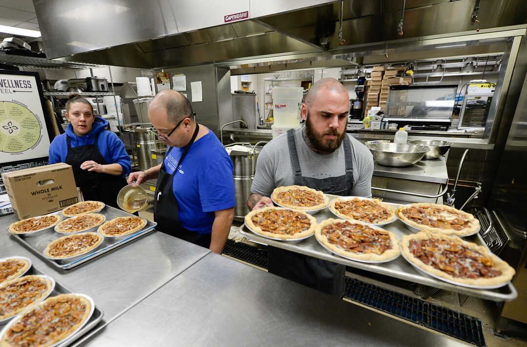 (Francisco Kjolseth  |  The Salt Lake Tribune)  Erica Soucie, Dennis Sisneros and A.J. Collette, from left, prepare pecan pies for the oven at Flourish Bakery before the Thanksgiving holiday as part of their "Pie it Forward" program. Flourish Bakery needs to find a new home before Christmas. The non-profit bakery teaches those who have been incarcerated or recovering from substance abuse the art of baking. The skills they learn help them get a job and become financially independent. The bakery has been housed at SLCC's South City campus, but the college has said they can no longer use the space.