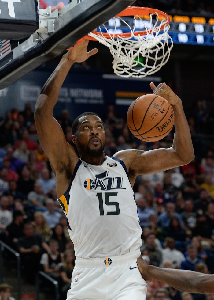 (Francisco Kjolseth  |  The Salt Lake Tribune)  Utah Jazz forward Derrick Favors (15) dunks over the Raptors in the first half of the preseason NBA game at Vivint Smart Home Arena Tuesday, Oct. 2, 2018, in Salt Lake City.
