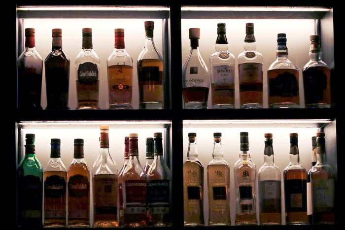 In this Dec. 10, 2019, photo a vast array of fine single malt scotch bottles are displayed at Wink & Nod, basement-dwelling, speakeasy-like bar, in Boston. In this era of bottomless mimosas, craft beers and ever-present happy hours, it’s striking to recall that 100 years ago the United States imposed a nationwide ban on the production and sale of all types of alcohol. (AP Photo/Charles Krupa)