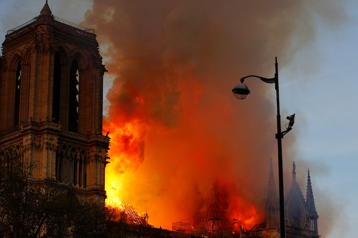 Notre Dame cathedral is burning in Paris, Monday, April 15, 2019. A catastrophic fire engulfed the upper reaches of Paris' soaring Notre Dame Cathedral as it was undergoing renovations Monday, threatening one of the greatest architectural treasures of the Western world as tourists and Parisians looked on aghast from the streets below. (AP Photo/Francois Mori)