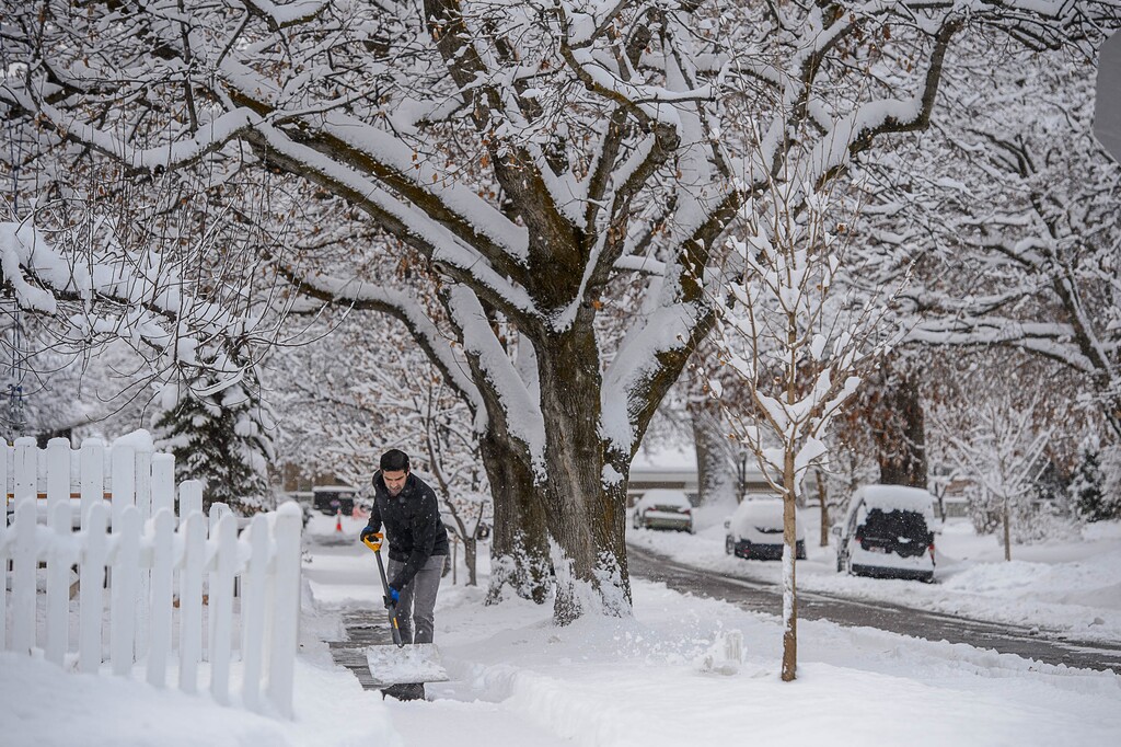(Trent Nelson | The Salt Lake Tribune) Aabir Malik shovels snow in Salt Lake City on Wednesday, Feb. 17, 2021. Many cities have ordinances about clearing snow and where you can park during and after a storm.