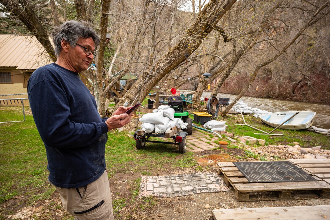 (Trent Nelson  |  The Salt Lake Tribune)  Wayne Hill checks water level reports on his phone while anticipating possible flooding at his home on the banks of the South Fork Ogden River east of Huntsville on Monday April 22, 2019.