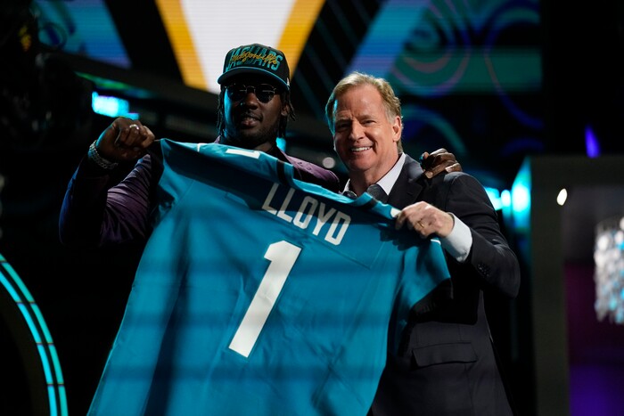 Utah linebacker Devin Lloyd stands with NFL Commissioner Roger Goodell after being chosen by the Jacksonville Jaguars with the 27th pick of the NFL football draft Thursday, April 28, 2022, in Las Vegas. (AP Photo/John Locher)