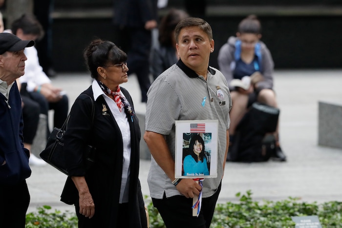 (Mark Lennihan | AP Photo) People gather for a ceremony marking the 18th anniversary of the attacks of Sept. 11, 2001 at the National September 11 Memorial, Wednesday, Sept. 11, 2019 in New York.