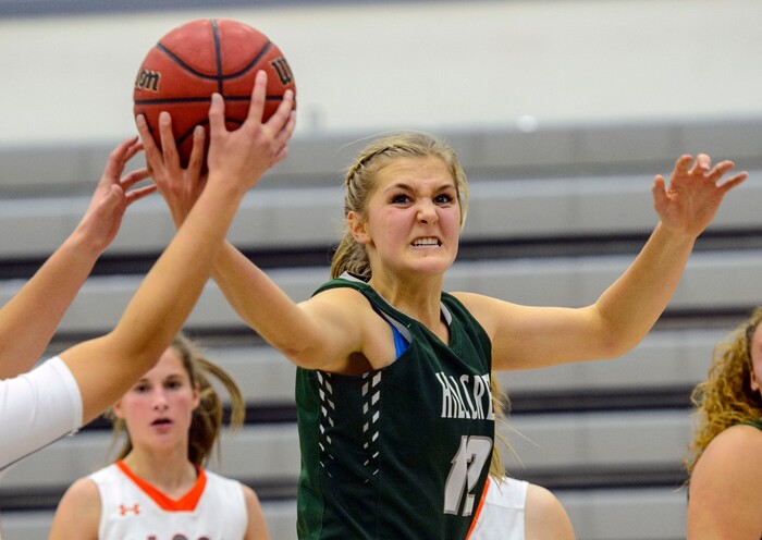 (Steve Griffin  |  The Salt Lake Tribune)  Hillcrest's Cara Snowder grits her teeth as she stretches for a rebound during game against SKyridge at Skyridge High School in Lehi Wednesday December 13, 2017.