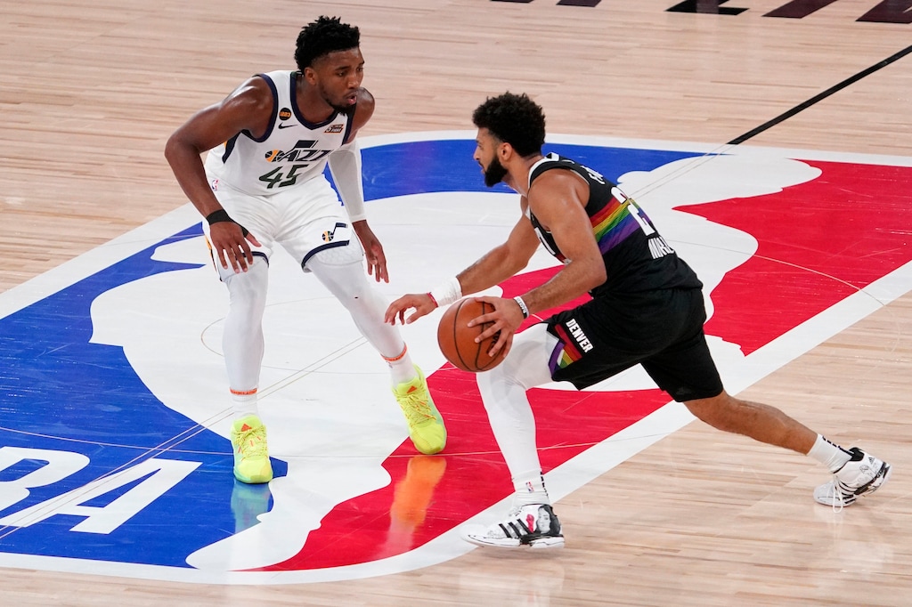 Utah Jazz's Donovan Mitchell (45) defends as Denver Nuggets' Jamal Murray (27) advances the ball down court during the second half an NBA first round playoff basketball game, Tuesday, Sept. 1,2020, in Lake Buena Vista, Fla. (AP Photo/Mark J. Terrill)
