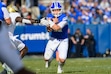 BYU quarterback Bear Bachmeier, center, runs the ball for a first down during the first half an NCAA college football game against Central Florida, Saturday, Nov. 29, 2025, in Provo, Utah. (AP Photo/Tyler Tate)