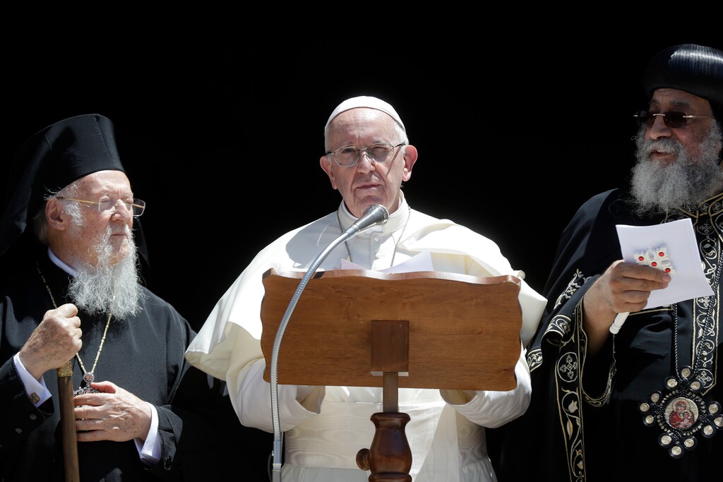 (AP Photo/Gregorio Borgia) Pope Francis, center, flanked by Ecumenical Patriarch Bartholomew I, left, and Tawadros II, Pope of Alexandria and Patriarch of the See of St. Mark, reads his message outside the St. Nicholas Basilica on the occasion of a daylong prayer for peace in the Middle East in Bari, southern Italy, Saturday, July 7, 2018.  Pope Francis denounced the "complicit silence" that has allowed violence to consume the Middle East and drive tens of thousands of Christians from their homes, during a remarkable gathering Saturday of Orthodox patriarchs and Catholic leaders united in praying for peace in the region.