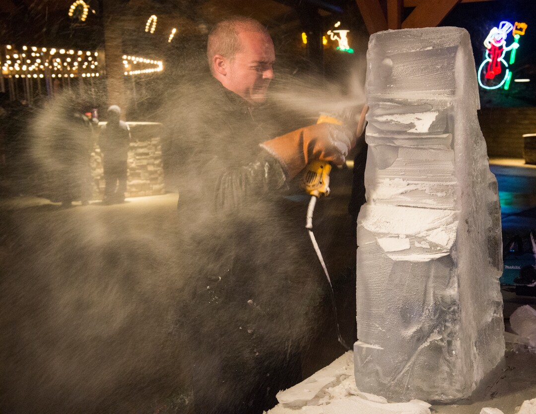 (Rick Egan  |  The Salt Lake Tribune)   The Ice Scuplture, Darron Kingston carves a block of ice into a wold, as the ZooLights at Hogle Zoo are turned on, Friday, Nov. 30, 2018. The lights continue  through December 31st, 