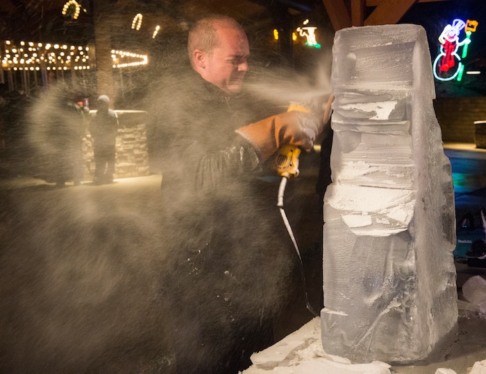 (Rick Egan  |  The Salt Lake Tribune)   The Ice Scuplture, Darron Kingston carves a block of ice into a wold, as the ZooLights at Hogle Zoo are turned on, Friday, Nov. 30, 2018. The lights continue  through December 31st, 


