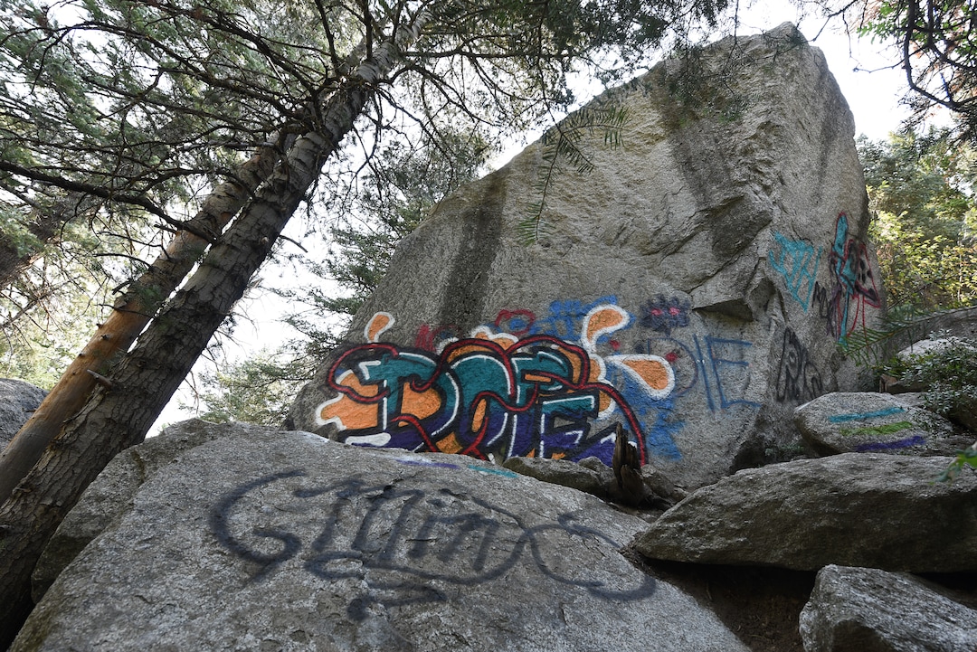 (Francisco Kjolseth  |  The Salt Lake Tribune)  Graffiti has proliferated in lower Little Cottonwood Canyon, where vandals, often wielding cans of fluorescent-colored spray paint, have covered granite faces, trees and structures. The vandalism is particularly apparent along the Temple Quarry Trail and the creek at the Moon Rock swimming hole and former pavilion site. Volunteers using donated equipment and solvents spend thousands of hours removing the paint from the rocks only to see graffiti return to the same faces or on rock nearby.