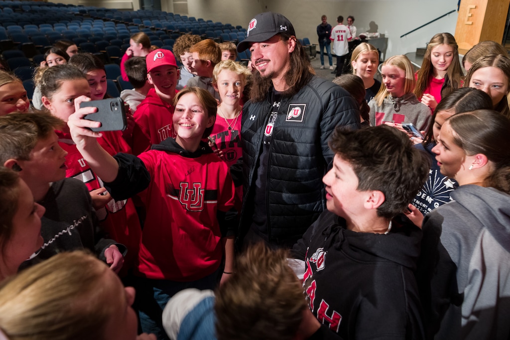 (Trent Nelson  |  The Salt Lake Tribune) Utah quarterback Cam Rising poses for photos with students at Eastmont Middle School in Sandy on Tuesday, Nov. 28, 2023.