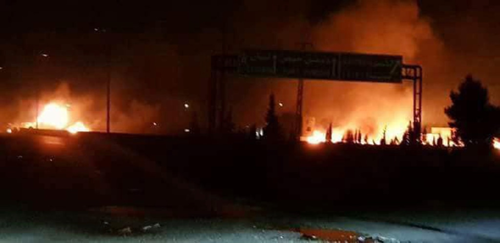(SANA via AP) This photo released on Wednesday, May 9, 2018, by the Syrian official news agency SANA, shows flames rising after an attack in an area known to have numerous Syrian army military bases, in Kisweh, south of Damascus, Syria. Syrian state-run media said Israel struck a military outpost near the capital Damascus on Tuesday, saying its air defenses intercepted and destroyed two of the incoming missiles. The reported attack came shortly after U.S. President Donald Trump announced he was withdrawing from the Iran nuclear deal, calling Tehran a main exporter of terrorism in the region.