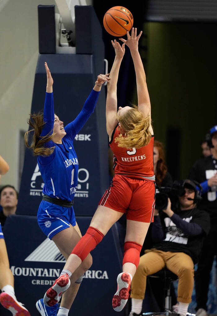 (Francisco Kjolseth | The Salt Lake Tribune) Utah Utes guard Gianna Kneepkens (5) stretches out for a shot against BYU Cougars guard Amanda Barcello (1) in basketball action between the Utah Utes and the Brigham Young Cougars, at the Marriott Center in Provo, on Saturday, Dec. 10, 2022.