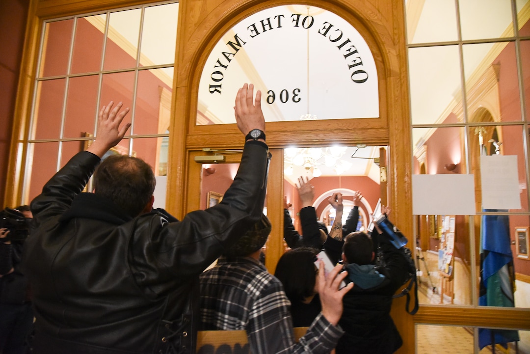 (Francisco Kjolseth  |  The Salt Lake Tribune)  "Hands up don't shoot" exclaim members of Utah Against Police Brutality and family of Cody Belgard, the popular Glendale rapper, who was shot by police last November, after trying to get a meeting scheduled with the mayor. For weeks, the family of Cody Belgard has asked to meet with Mayor Biskupski to discuss his shooting by SLCPD, to no avail.