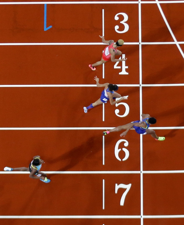 United States' Phyllis Francis, second bottom, crosses the line to win the gold medal in the Women's 400m final ahead of United States' Allyson Felix, bronze, and Bahrain's Salwa Eid Naser, silver, top, during the World Athletics Championships in London Wednesday, Aug. 9, 2017. (AP Photo/David J. Phillip)