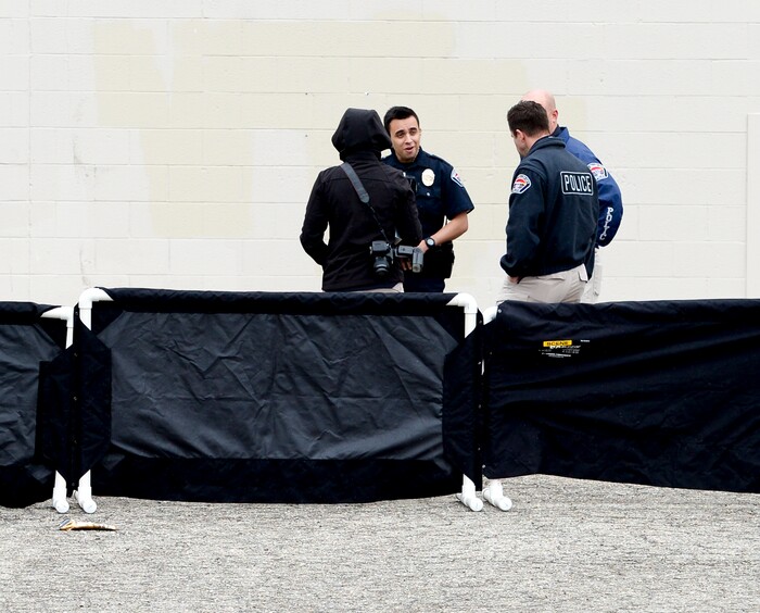 (Leah Hogsten  |  The Salt Lake Tribune)  West Valley City police investigate the scene at the old Kmart building at 4100 South and 1770 West in West Valley City where a body was found in a covered storm drain Friday, April 6, 2018. 