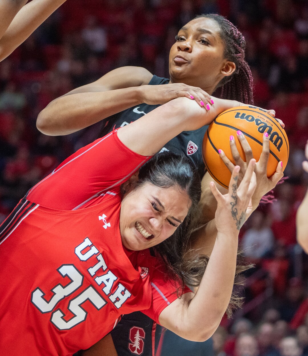 (Rick Egan | The Salt Lake Tribune) Stanford Cardinal guard Agnes Emma-Nnopu (2) grabs the ball and the arm of Utah Utes forward Alissa Pili (35), in PAC-12 action, at the Jon M. Huntsman Center, on Saturday, Feb. 25, 2023.