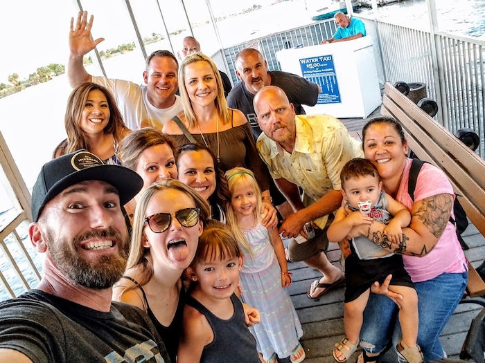 This undated photo provided by Ryan Miller shows Nicol Kimura, back left, with Ryan Miller, Michelle Miller, Nicol Kimura, Tracy Gyurina, Heather Bodwell, Chad Elliott, Ryan Williams, Trevor Brown, Casey Bodwell, and Christina Brown. Kimura was one of the people killed in Las Vegas after a gunman opened fire on Sunday, Oct. 1, 2017, at a country music festival. (Ryan Miller via AP)