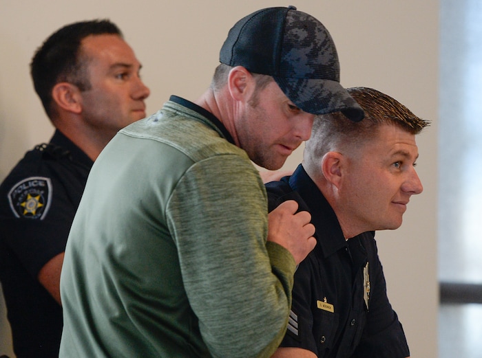(Francisco Kjolseth  |  The Salt Lake Tribune)  Sgt. Jeremy Owens, center, comforts Sgt. Shawn McKinnon as the surveillance video of a suicidal subject call on April 5, 2018, that injured McKinnon and three other officers is played for the media on Thursday, April 12, 2018. The officers responded to a man who entered a Chevron gas station store and doused himself with gasoline. As the officers tried to get a lighter from the manÕs hand, the man lit himself on fire. 