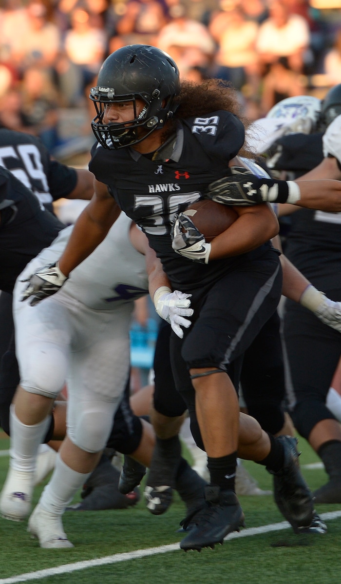(Leah Hogsten  |  The Salt Lake Tribune) Alta's Tu'u Afu with the carry. Lehi High School leads Alta High School 42-28 during their game, Friday, August 18, 2017 in Sandy. 