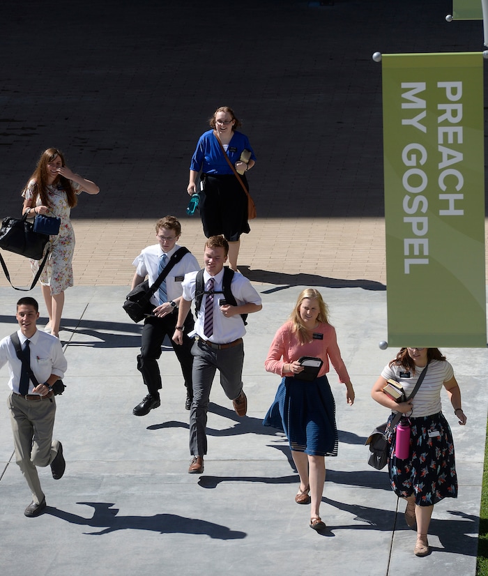 Al Hartmann  |  The Salt Lake TribuneMissionaries come and go on the plaza of the new building at the Missionary Training Center in Provo Wednesday July 26.  Some in a hurry.  