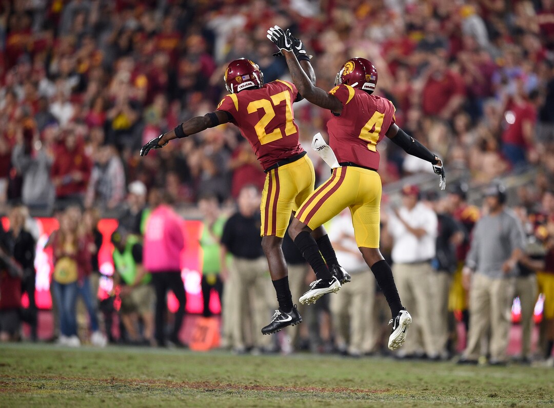 Southern California safety Chris Hawkins, right, and cornerback Ajene Harris celebrate during the second half of an NCAA college football game against Utah in Los Angeles, Saturday, Oct. 14, 2017. USC won 28-27. (AP Photo/Kelvin Kuo)