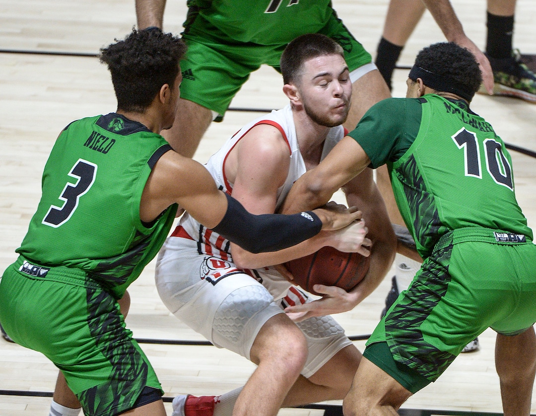 (Leah Hogsten  |  The Salt Lake Tribune) Utah Utes guard Rylan Jones (15) is stripped of the ball by Utah Valley Wolverines guard Blaze Nield (3) and Utah Valley Wolverines guard Jaden McClanahan (10) as the Utes host Utah Valley University on Tuesday, Dec. 15, 2020 at the Jon M. Huntsman Center. The Utes won 75-67.